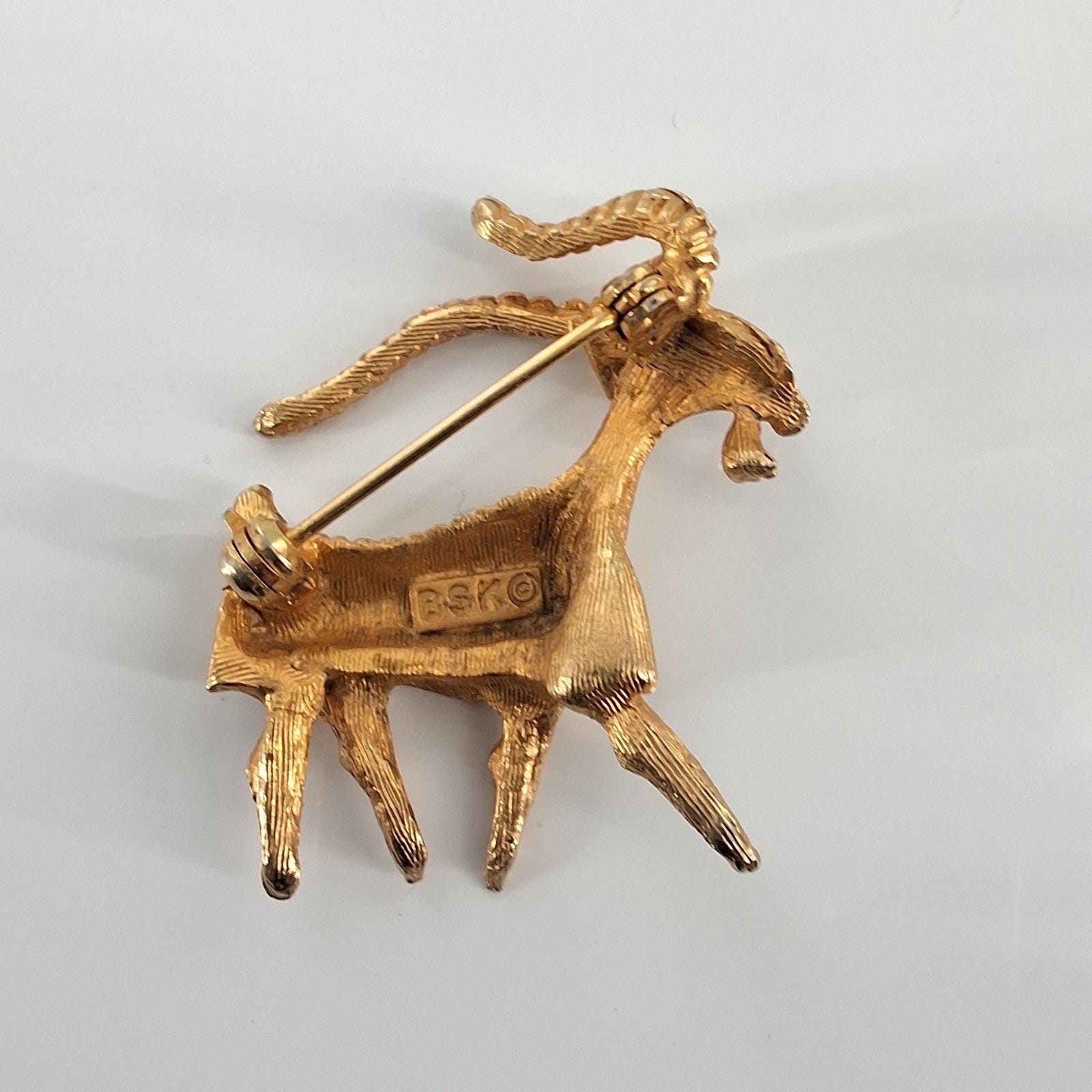 BSK Vintage Gold Tone Ram Ibex Brooch Red Rhinestone Eye Capricorn Pin